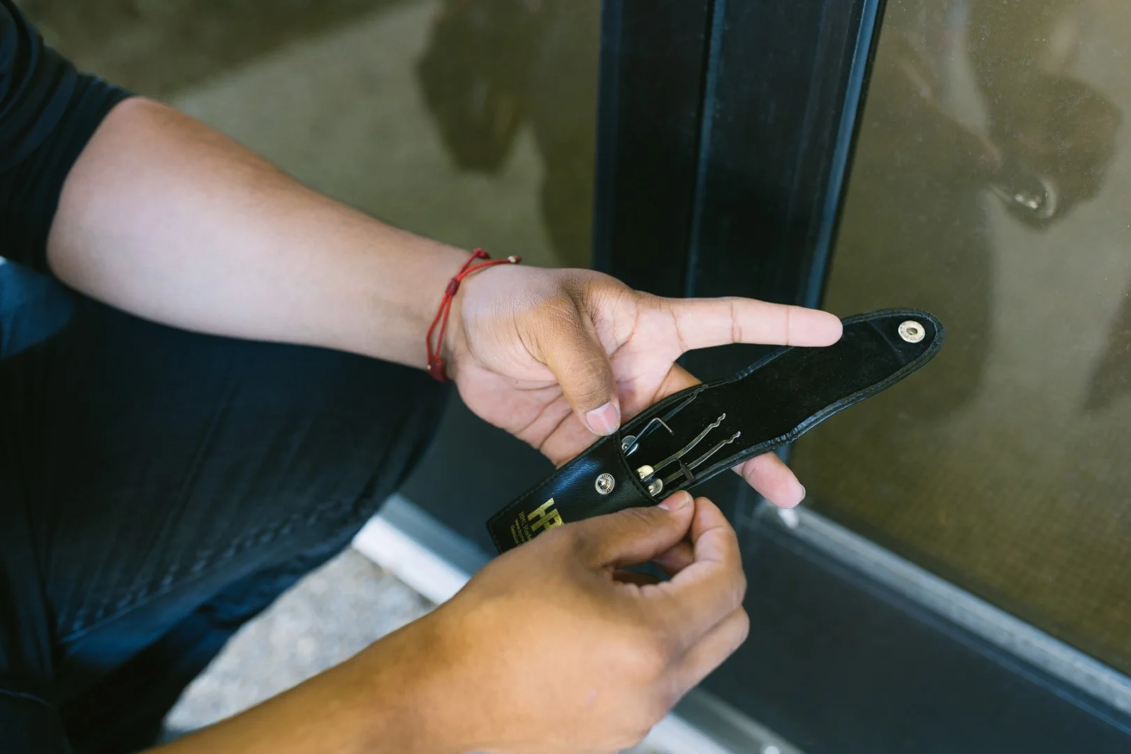 Pick Set Close Up (Large) Technician working on a storefront glass door